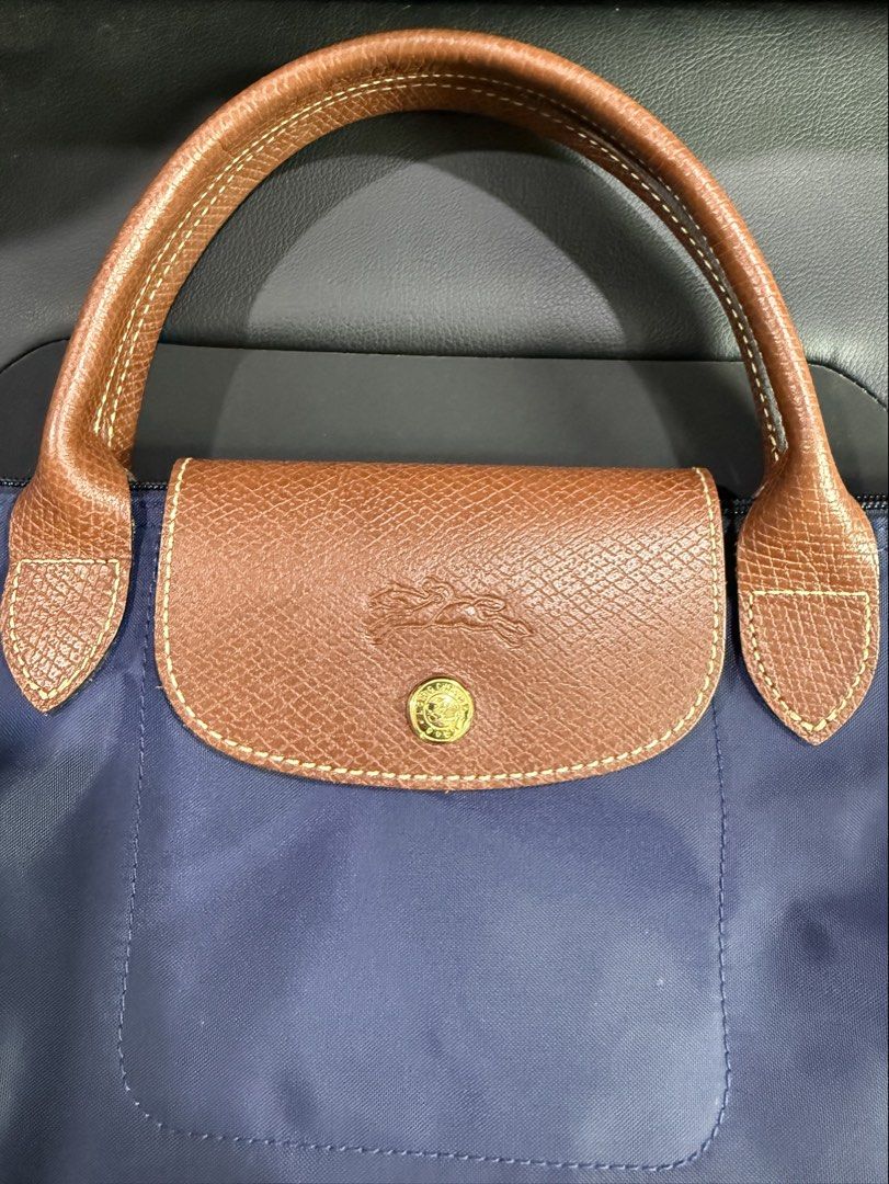AUTHENTIC LONGCHAMP BAG (Category: Shoulder Bags) located in Paranaque City. Submitted by lulusthreadsandthings (Listing ID 1462652062, Image 3). Description: Authentic Long Champ Bag - Medium size - Short handle - Navy blue color - Brown handle - Mint condition - Price at 4,500 (negotiable) - Shipping fee shoulder by buyer See actual photos .