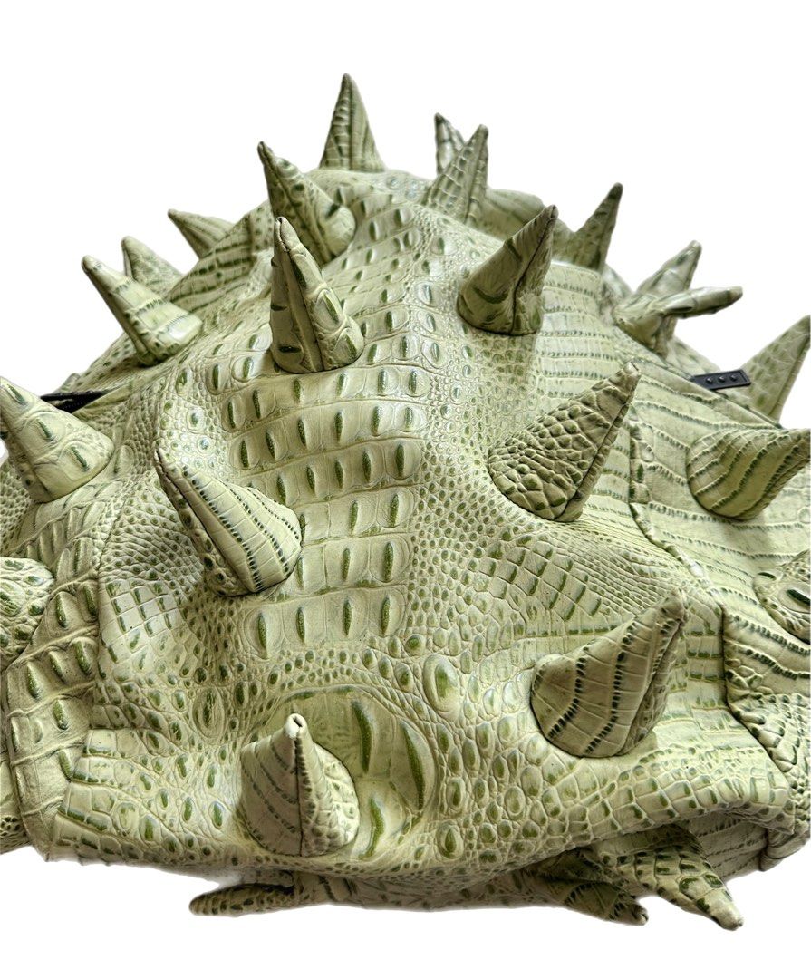 Authentic MadPax Crocodile Spiked Backpack (Category: Backpacks) located in Cagayan de Oro. Submitted by divinephoenix (Listing ID 1462546087, Image 1). Description: - Unique green backpack - Features a striking crocodile texture - Adorned with spikes all over - Padded straps and mesh back for ultimate comfort - Showcases the iconic MadPax logo - Make a bold statement with this eye-catching bag! - Check photos for more details.