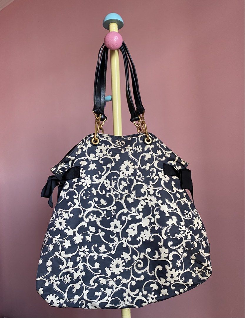 AUTHENTIC MARC JACOBS DESIGNER BAG (Category: Tote Bags) located in Binmaley. Submitted by vanilla_style (Listing ID 1462476620, Image 2). Description: • Verified Marc Jacobs plate + engraved zipper pull • Design: Black & Cream Floral Scroll Print — signature ribbon bows • Material: Lightweight premium nylon | Leather top handles • Hardware: Gold-tone finish (minor tarnish from gentle use) • Lining: Black satin — 1 zip pocket + 2 slot pockets • M