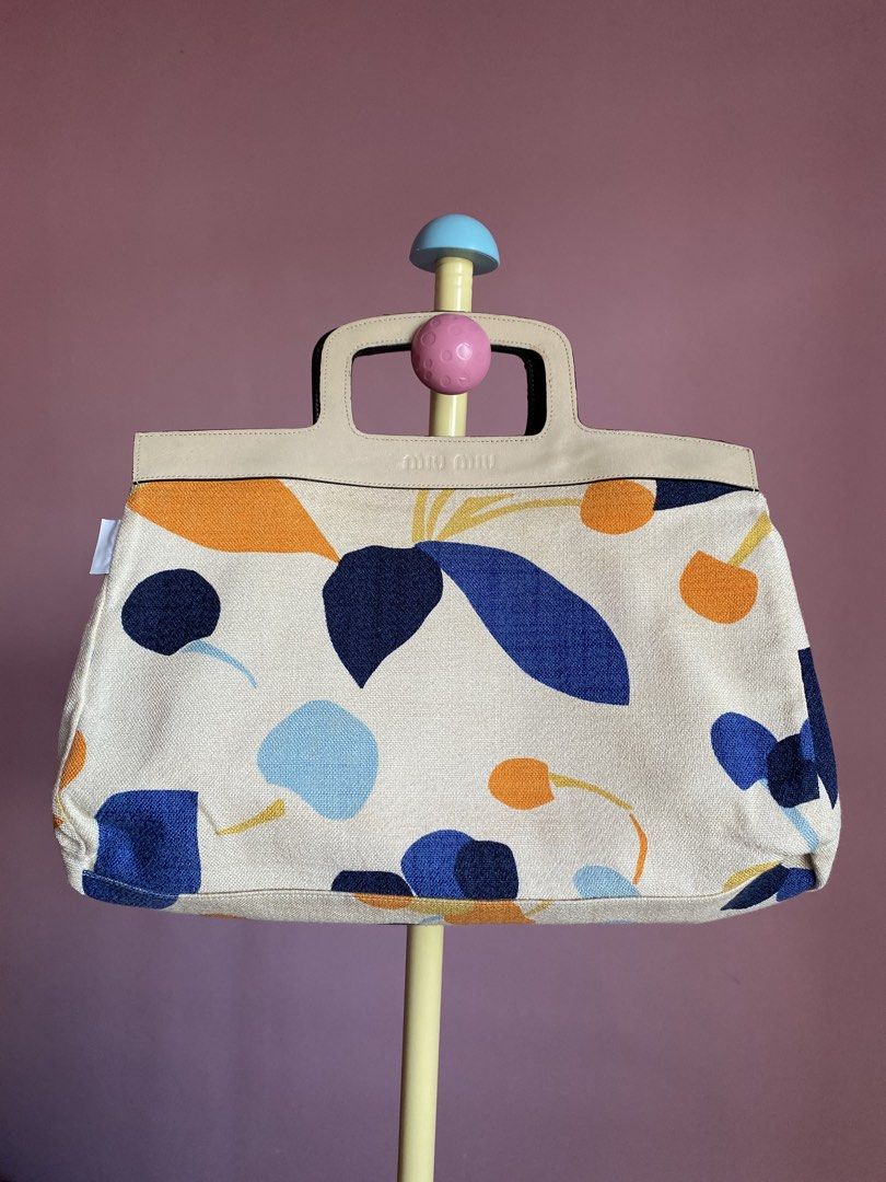 AUTHENTIC MIU MIU Reversible Tote — Made in Italy 🇮🇹 (Category: Tote Bags) located in Binmaley. Submitted by vanilla_style (Listing ID 1462470921, Image 1). Description: • 2 bags in 1! Reversible design 🇮🇹 ✅ Side A: Cream canvas w/ abstract fruit print + embossed leather handle ✅ Side B: Full premium black leather w/ embossed logo • Both sides usable — change look anytime hehe • Condition: Preloved, well-cared, need wash inside po :)) • Tags 