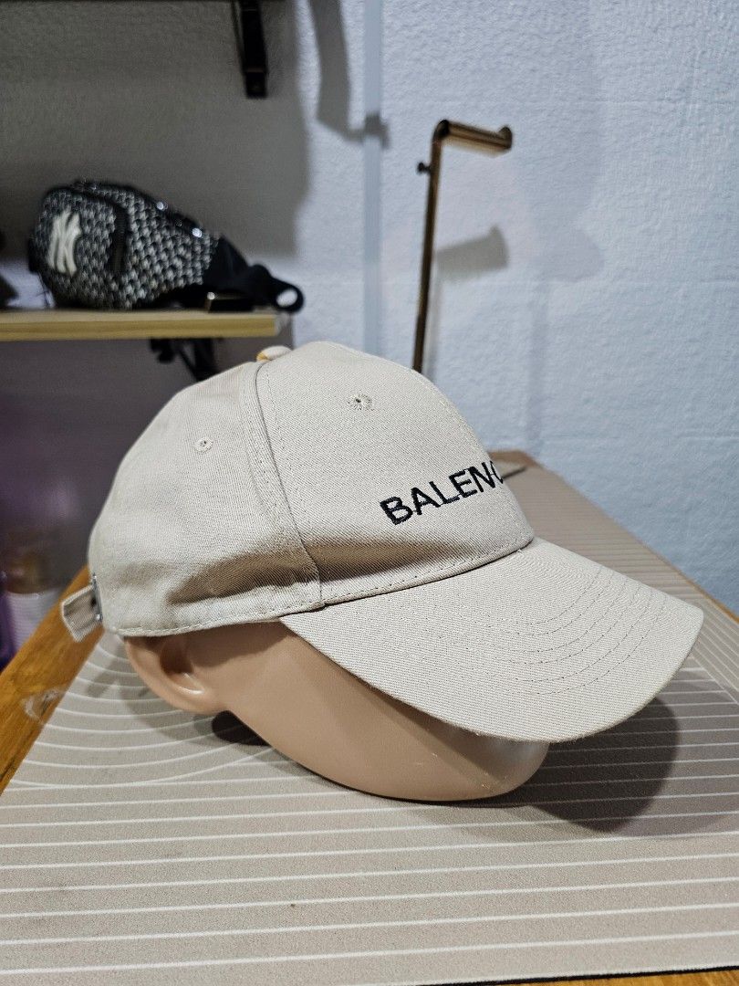 Balenciaga cotton baseball cap (Category: Caps & Hats) located in Baguio. Submitted by kayeonlineshop (Listing ID 1462550911, Image 2). Description: -beige Balenciaga cotton baseball cap featuring bold black embroidered lettering across the front panel.