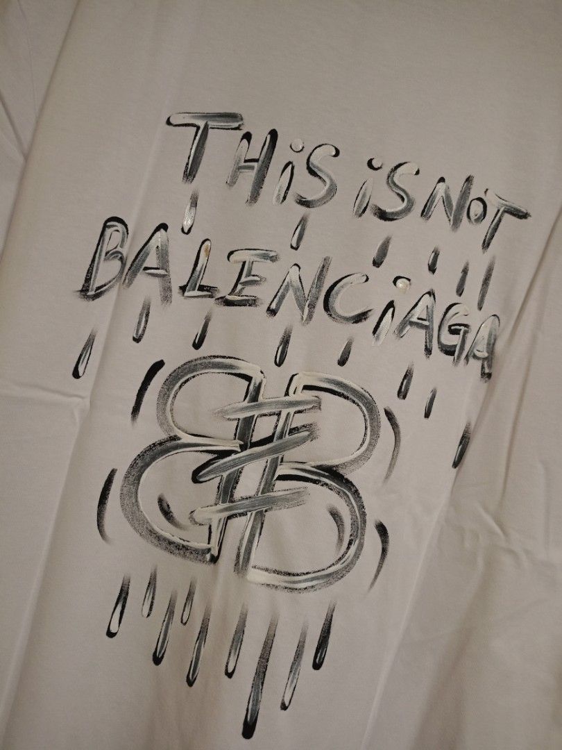 Balenciaga "This is Not" Shirt (Category: Luxury Apparel) located in Valenzuela. Submitted by One.Only.Nan (Listing ID 1462626517, Image 2). Description: XL on tag Actual W23" L30" Excellent condition 10 color rate MOP GCASH MAYA AUB BPI VALENZUELA CITY LOC.