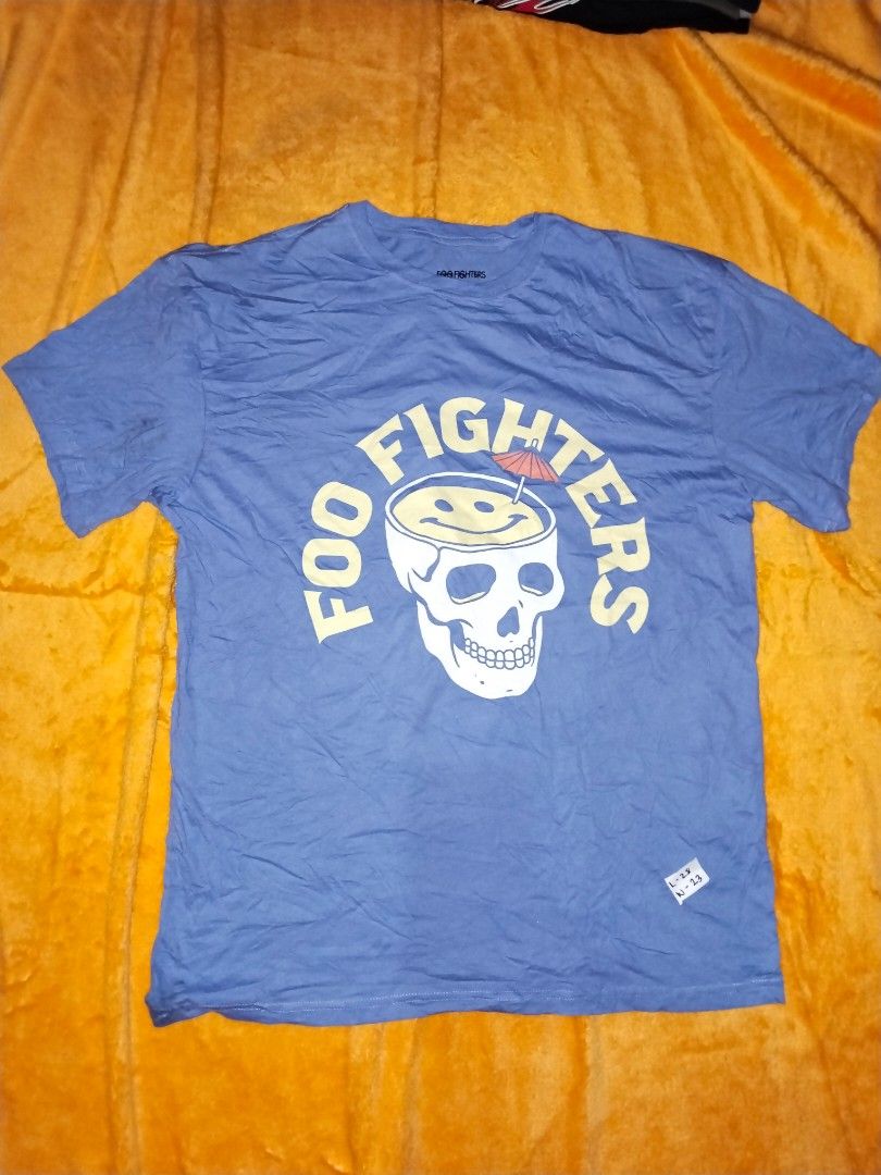 Band Tee XL (Category: Tshirts & Polo Shirts ) located in Mabalacat. Submitted by al_amin_thrift (Listing ID 1462445622, Image 1). Description: Foo Fighters Official 2024 Skull Cocktail Tee — Size S/M L 30 W 23 ​ - ✅ Authentic licensed Foo Fighters merchandise ​ - Iconic skull + smiley cocktail graphic — fan‑favorite design ​ - 100% premium cotton — soft & comfortable ​ - Slate blue — stylish everyday color ​ - Size: S/M ​ - Pre‑owned: clean, no 