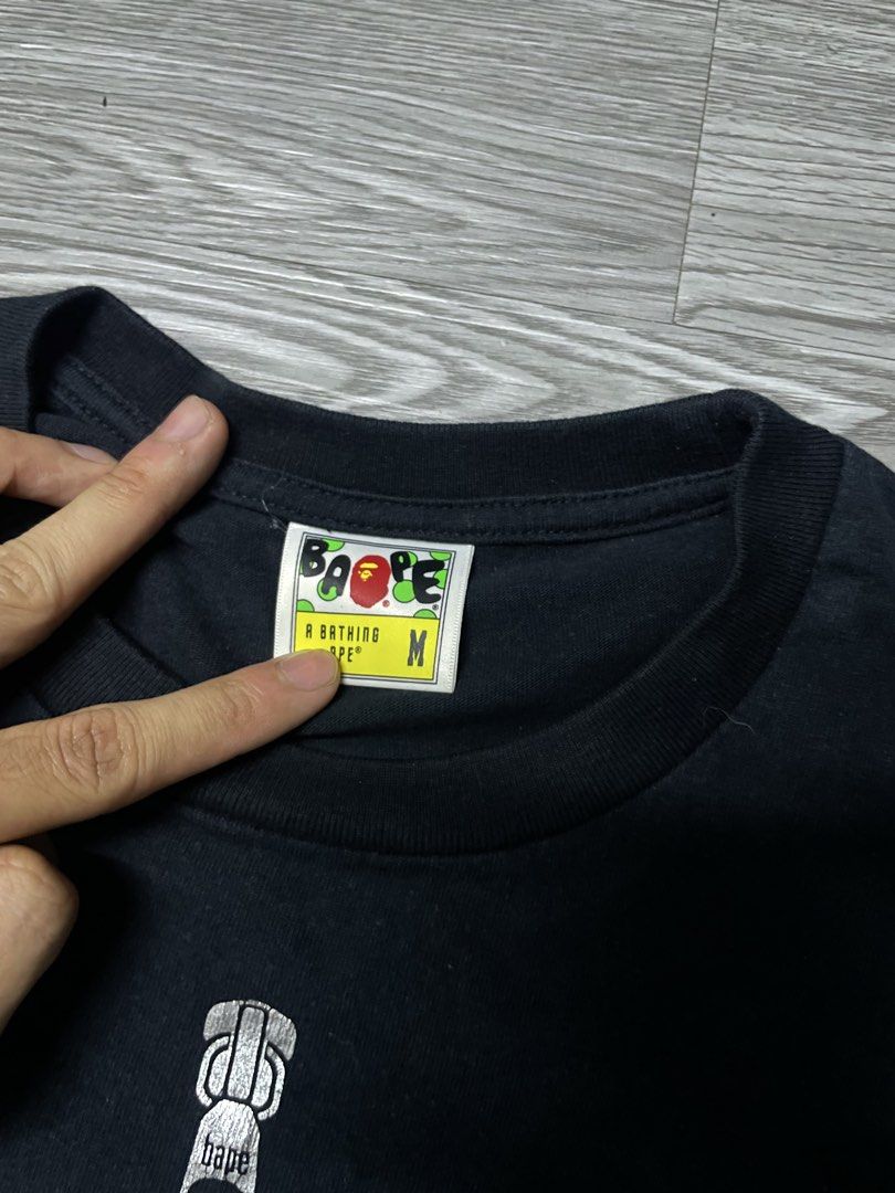 BAPE Shark Tee (Category: Tshirts & Polo Shirts ) located in Manila. Submitted by yourfavoriteplug (Listing ID 1462508180, Image 3). Description: - Authentic Black BAPE T-Shirt - Features the iconic camouflage shark mouth graphic - Zipper detail on the design - Size: Medium (M) - Essential piece for any streetwear enthusiast.