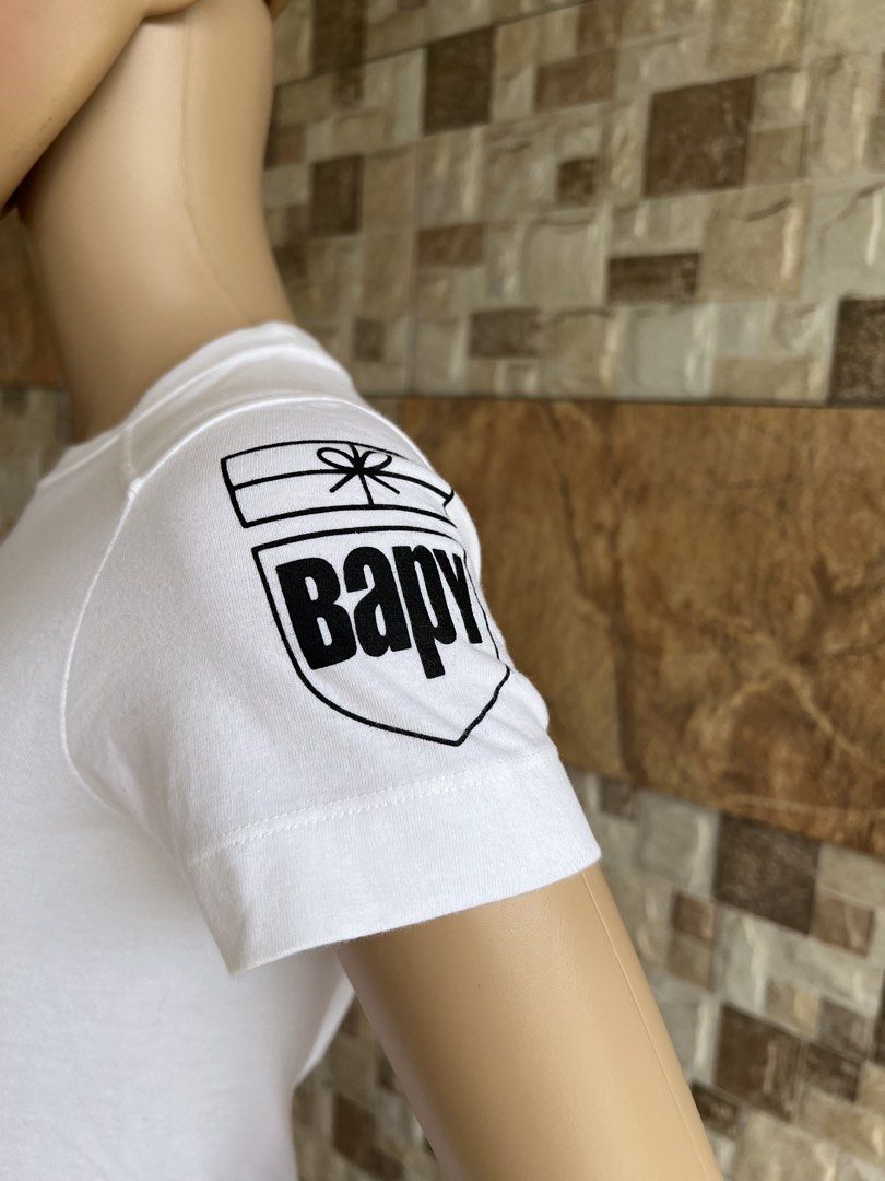 BAPY BY BATHING APE - GRAPHIC DESIGN BABY TEE (Category: Shirts) located in Bacolod City. Submitted by timelessbyjosh (Listing ID 1461732642, Image 3). Description: BEST FOR STREETWEAR & Y2K OUTFITS SIZE : ACTUAL COLOR : WHITE COLOR RATE : 10 OUT OF 10 CONDITION : NEAR NEW MATERIAL : 100 % COTTON MADE IN : JAPAN FLAWS : NONE DIMENSIONS LENGTH - 21. 5 WIDTH - 15. 5 MEASUREMENT TAKEN WHILE LAYING FLAT. PLEASE COMPARE THE MEASUREMENT WITH YOUR GARME