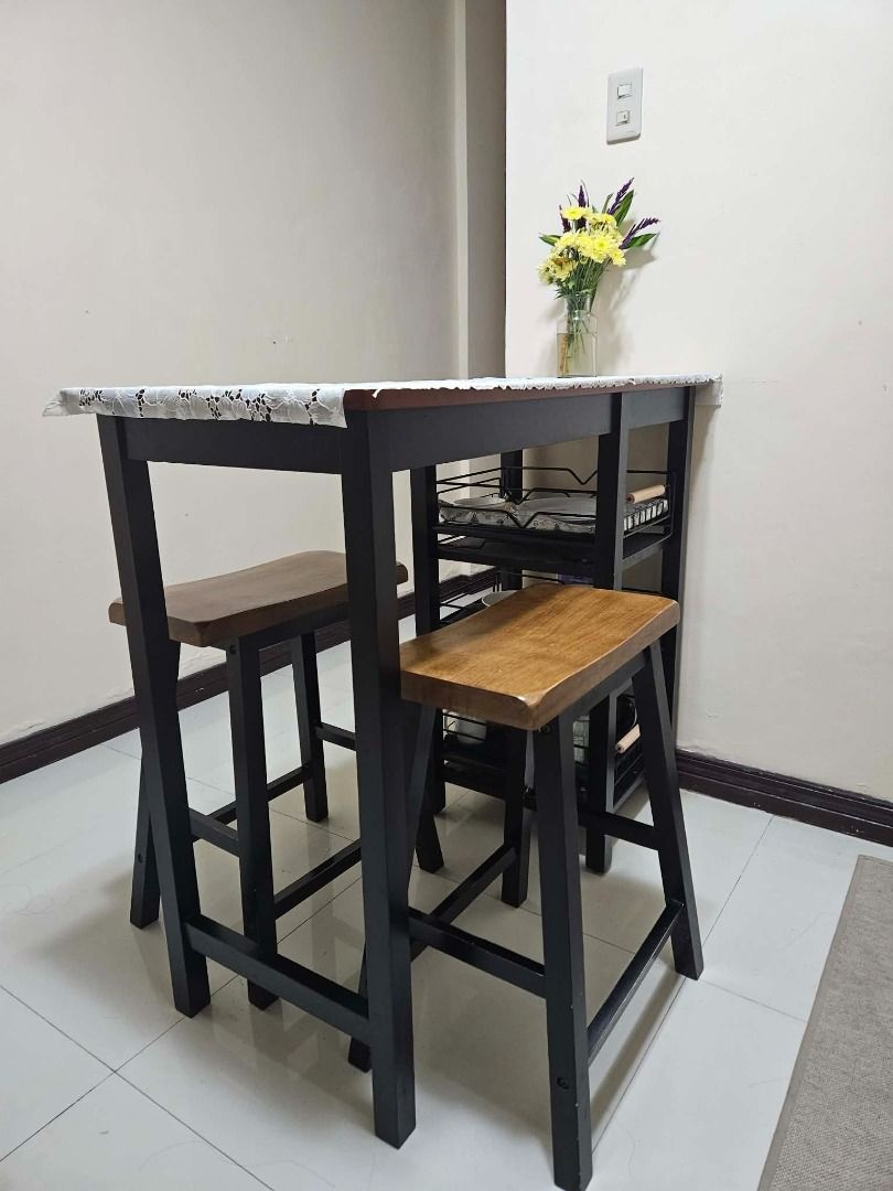 Bar Table Dining Set with Open Shelves for Storage (Category: Tables & Sets) located in Cainta. Submitted by cannappy (Listing ID 1462650559, Image 2). Description: Compact dining set perfect for small spaces. It's made of solid Malaysian rubber wood and has 3 layers of open shelves that can be used for storage. This comes with 3 removable metal storage racks (bought separately from the orange app) that fits perfectly into the shelves. Dimensions