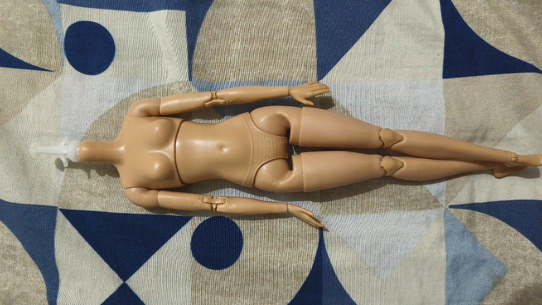 Barbie Doll Body with Articulated Joints (Category: Kids Toys) located in Manila. Submitted by joanalane76763 (Listing ID 1462621821, Image 1). Description: - Articulated Barbie doll body - Light tan skin tone - Posable joints: elbows, wrists, knees, and hips - Head is missing - White plastic piece in neck joint - Ideal for custom doll projects or replacing a broken doll body.
