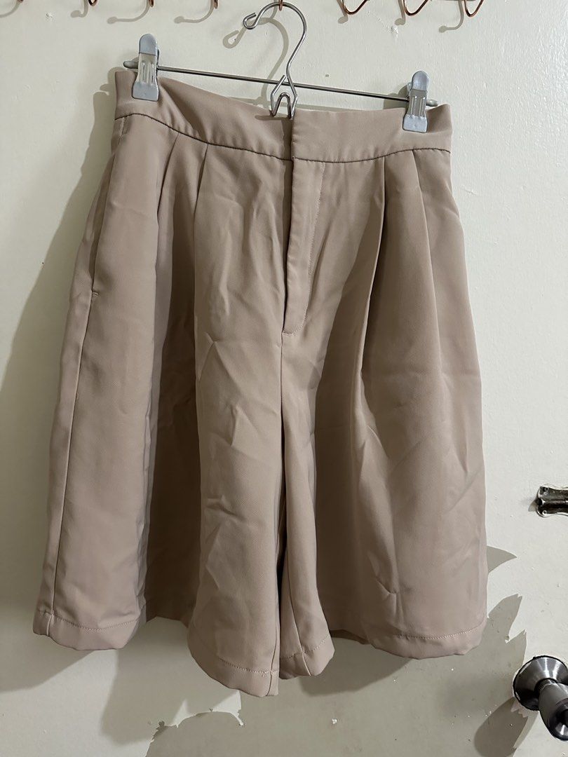 Beige Pleated High-Waisted Shorts (Category: Shorts) located in Quezon City. Submitted by jiinalin (Listing ID 1462666208, Image 1). Description: - Cute beige shorts - High-waisted fit - Front pleats for structure - Comfortable elastic waistband at the back - Functional pockets - Perfect for casual or dressy occasions.