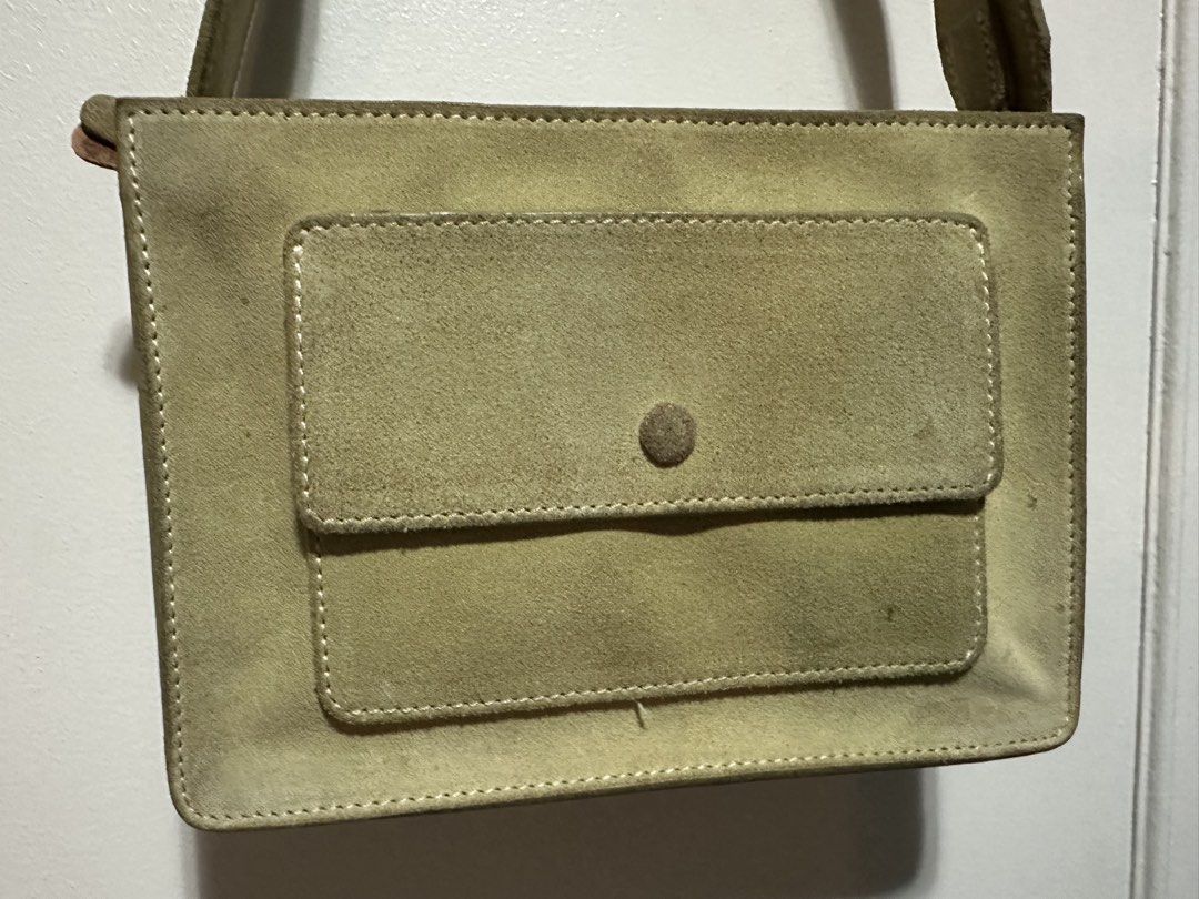 Beige Suede Shoulder Bag with Front Pocket (Category: Shoulder Bags) located in Paranaque City. Submitted by gianina129 (Listing ID 1462576134, Image 2). Description: - Light beige suede shoulder bag - Front flap pocket with button closure - Adjustable strap with side buttons - Simple and classic design - Ideal for everyday use.