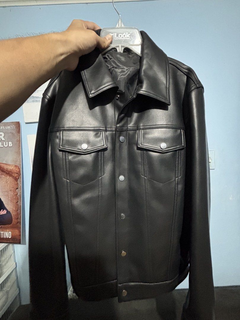 Black Faux Leather Jacket (Category: Coats, Jackets and Outerwear) located in Cainta. Submitted by iam.constantin (Listing ID 1462570771, Image 1). Description: - Classic black faux leather jacket - Button-up front - Two chest pockets - Collared neckline - Versatile for casual or dressed-up outfits.