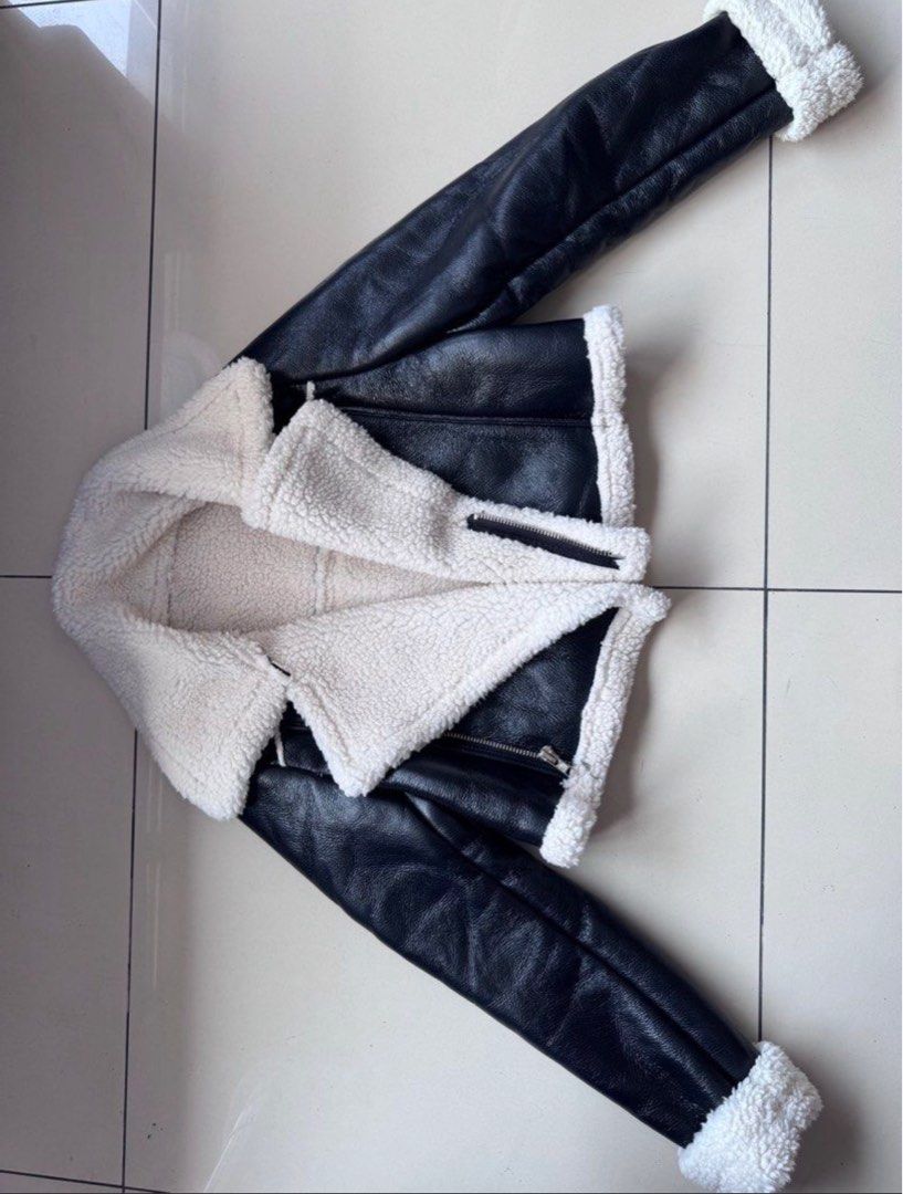 Black Faux Leather Sherpa Lined Biker Jacket (Category: Coats, Jackets and Outerwear) located in Manila. Submitted by decluterthings888 (Listing ID 1462439983, Image 1). Description: - Super cozy black faux leather jacket - Lined with soft white sherpa for warmth - Classic biker style with zip front and collar - Looks great layered over anything - Perfect for cooler weather - Great addition to your wardrobe.