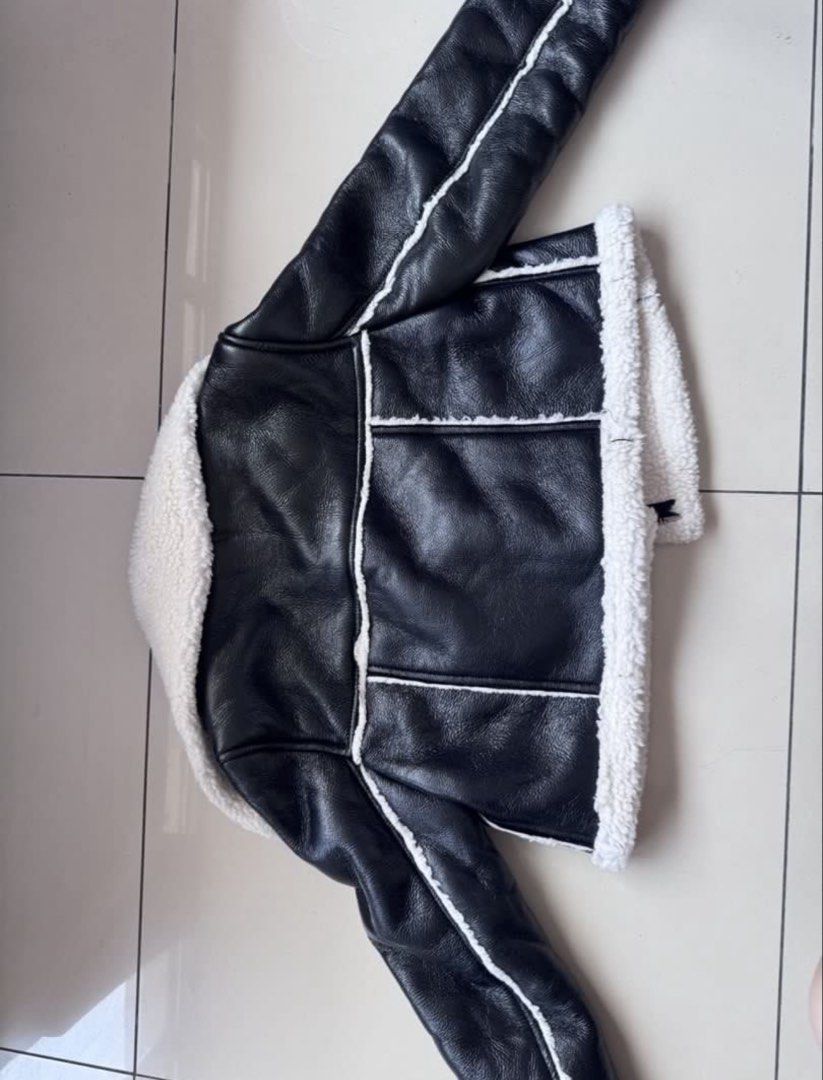 Black Faux Leather Sherpa Lined Biker Jacket (Category: Coats, Jackets and Outerwear) located in Manila. Submitted by decluterthings888 (Listing ID 1462439983, Image 2). Description: - Super cozy black faux leather jacket - Lined with soft white sherpa for warmth - Classic biker style with zip front and collar - Looks great layered over anything - Perfect for cooler weather - Great addition to your wardrobe.