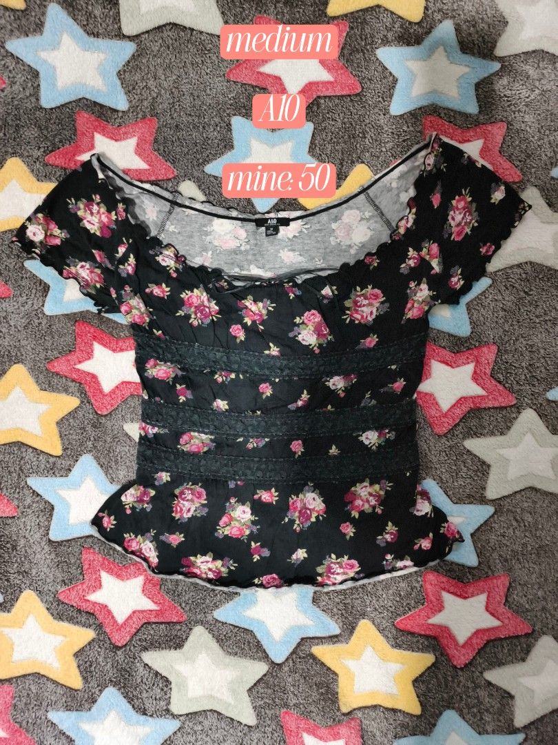 Black Floral Lace-Trimmed Blouse (Category: Blouses) located in Cebu City. Submitted by straw.berry.milk.24 (Listing ID 1462647528, Image 1). Description: - Chic black top with a lovely floral print. - Trendy off-shoulder design with delicate ruffled edges. - Flattering cinched waist accentuated by beautiful lace detailing. - Adjustable tie-back closure for a perfect fit. - Size Medium..