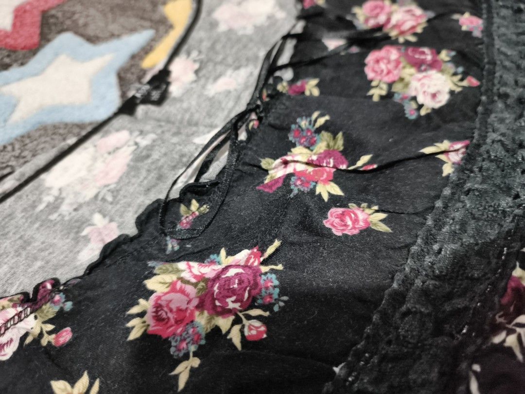 Black Floral Lace-Trimmed Blouse (Category: Blouses) located in Cebu City. Submitted by straw.berry.milk.24 (Listing ID 1462647528, Image 2). Description: - Chic black top with a lovely floral print. - Trendy off-shoulder design with delicate ruffled edges. - Flattering cinched waist accentuated by beautiful lace detailing. - Adjustable tie-back closure for a perfect fit. - Size Medium..