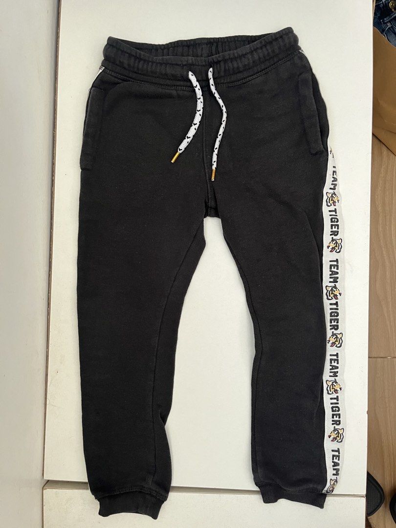 Black Joggers with "Team Tiger" Side Stripe (Category: Joggers) located in Las Pinas. Submitted by chelcie.sindhy (Listing ID 1462457225, Image 1). Description: - Black joggers - 'Team Tiger' stripe detail on the side - Elastic waistband with adjustable drawstring - Cuffed ankles - Ideal for casual wear or sports activities.