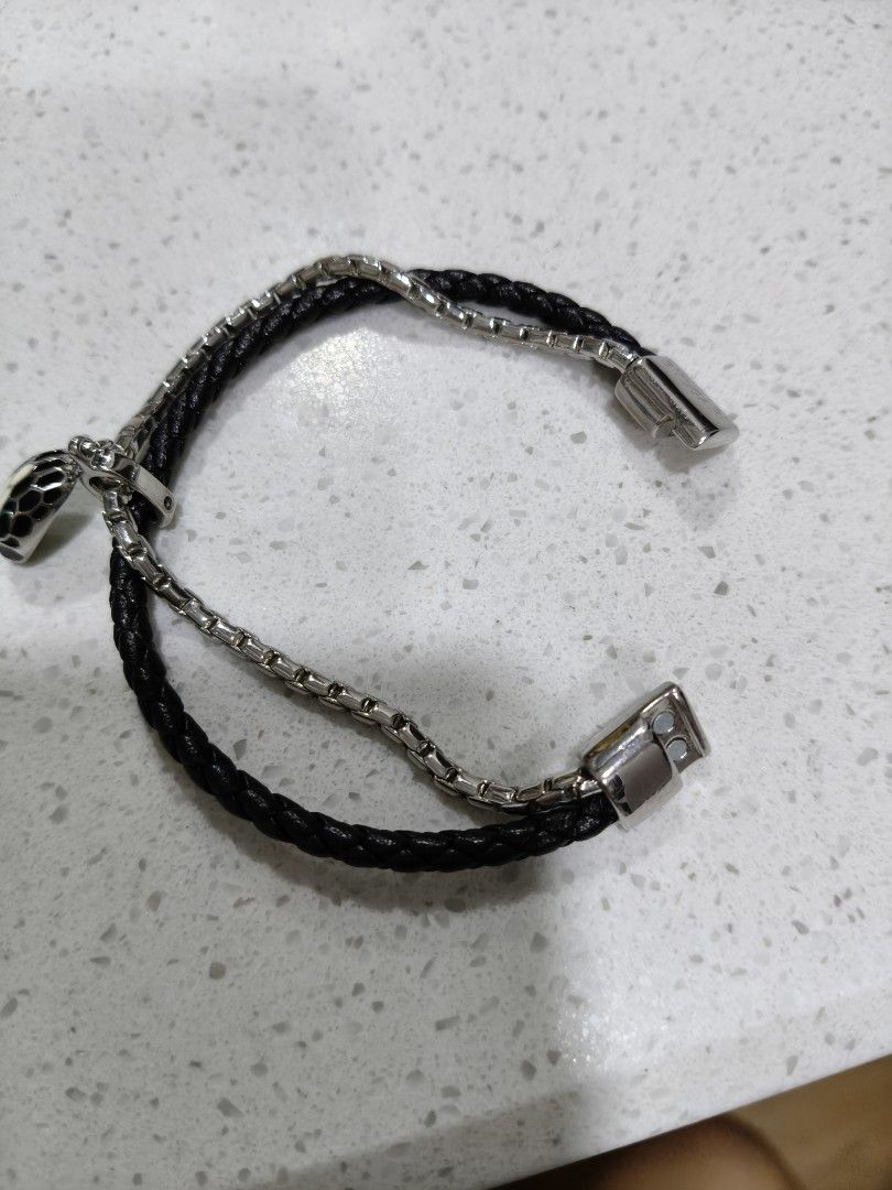 Black Leather Bracelet with Snake Charm (Category: Bracelets) located in Tarlac. Submitted by momma02 (Listing ID 1462460048, Image 3). Description: - Double strand bracelet like B^lgari Srpenti - One strand: Black braided leather - Second strand: Silver-tone chain - Magnetic clasp closure - Comes with a black and white enamel snake charm - Stylish and eye-catching design size: 16cm.