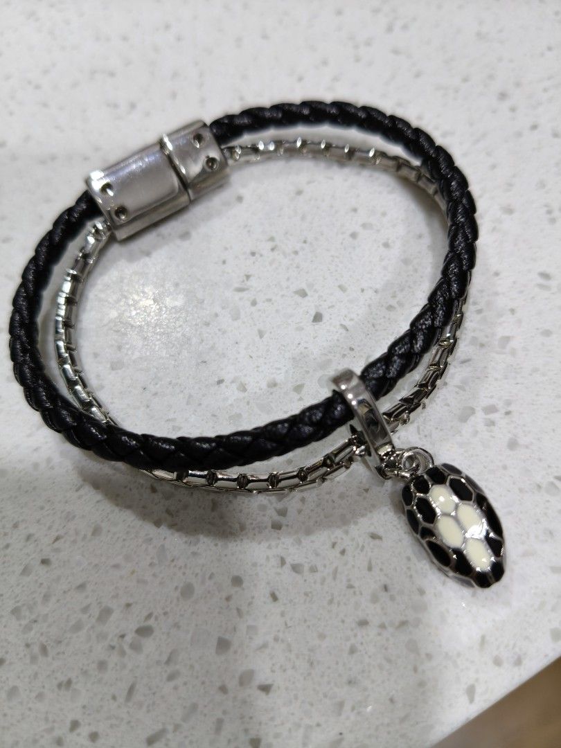 Black Leather Bracelet with Snake Charm (Category: Bracelets) located in Tarlac. Submitted by momma02 (Listing ID 1462460048, Image 1). Description: - Double strand bracelet like B^lgari Srpenti - One strand: Black braided leather - Second strand: Silver-tone chain - Magnetic clasp closure - Comes with a black and white enamel snake charm - Stylish and eye-catching design size: 16cm.