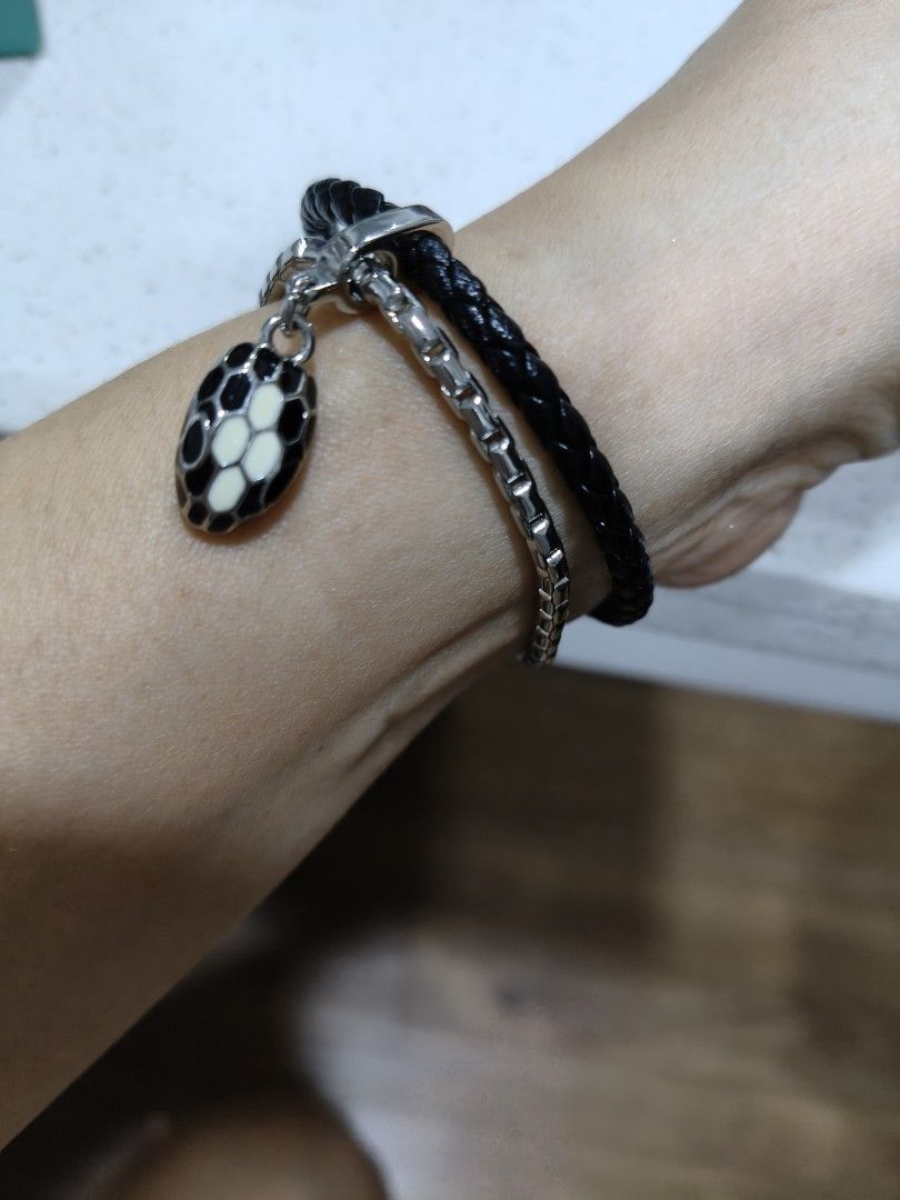 Black Leather Bracelet with Snake Charm (Category: Bracelets) located in Tarlac. Submitted by momma02 (Listing ID 1462460048, Image 2). Description: - Double strand bracelet like B^lgari Srpenti - One strand: Black braided leather - Second strand: Silver-tone chain - Magnetic clasp closure - Comes with a black and white enamel snake charm - Stylish and eye-catching design size: 16cm.