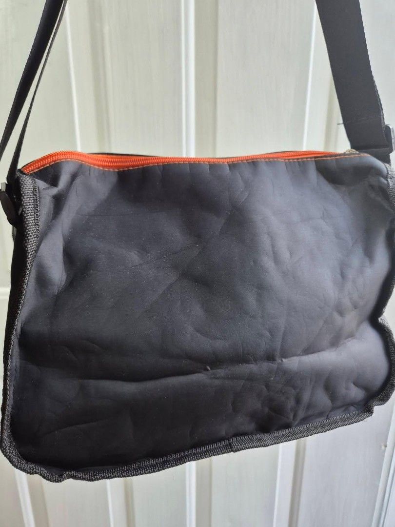 Black Messenger Bag with Orange Accents (Category: Luxury Bags & Wallets) located in Manila. Submitted by princessahshop (Listing ID 1462568694, Image 3). Description: No brand nylon sling ₱199 only + sf 🎀Color rate 9/10 🎀Issue dami sign of tupi 🎀Size Height 7 inches, length 11 inches, depth 5 inches.
