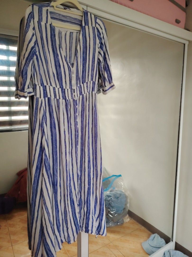 Blue and White Striped Maxi Dress (Category: Dresses) located in Agdangan. Submitted by limeineghl (Listing ID 1462509408, Image 1). Description: - Flowy maxi dress - Blue and white vertical stripe pattern - V-neckline - Buttons down the front - Elastic cinched waist - Short sleeves with rolled cuffs - Ideal for casual outings or beach days.