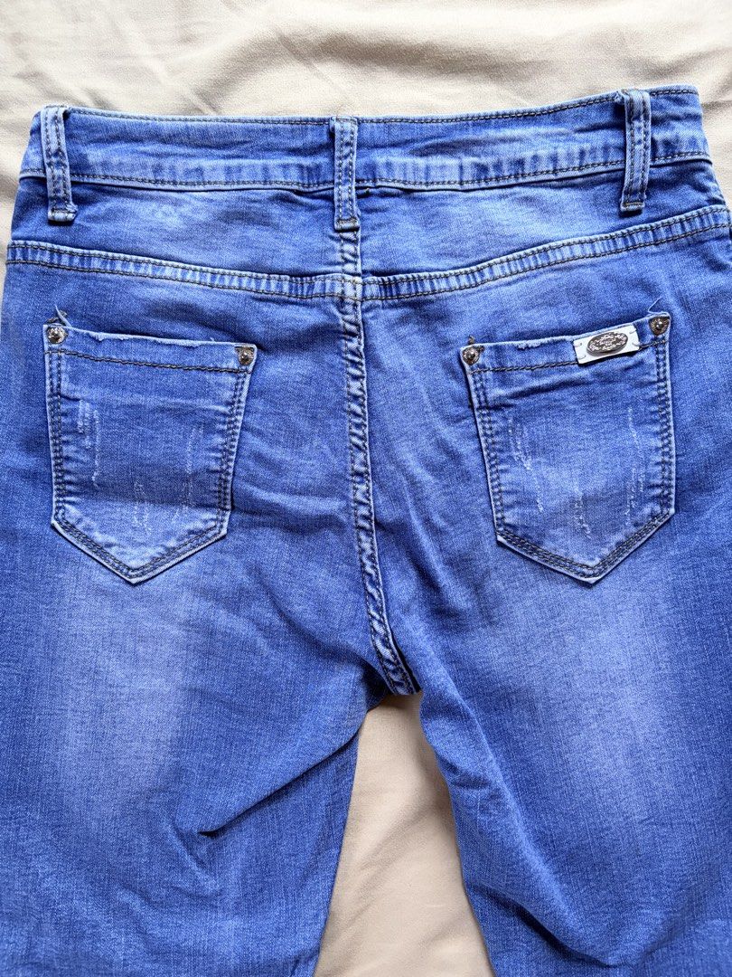 Blue Denim Jeans (Category: Jeans) located in Tabaco. Submitted by shae_3 (Listing ID 1462516081, Image 2). Description: - Size: 27 inches - Length: 32 inches - Distressed look on knees and hem - Cuffed bottoms with frayed edges - Button and zip closure - Classic five-pocket styling - Comfortable fit for everyday wear - Perfect for your casual wardrobe.