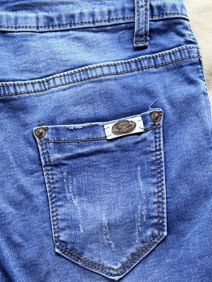 Blue Denim Jeans (Category: Jeans) located in Tabaco. Submitted by shae_3 (Listing ID 1462516081, Image 3). Description: - Size: 27 inches - Length: 32 inches - Distressed look on knees and hem - Cuffed bottoms with frayed edges - Button and zip closure - Classic five-pocket styling - Comfortable fit for everyday wear - Perfect for your casual wardrobe.