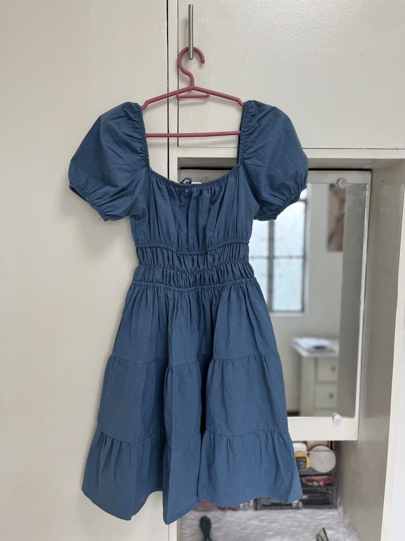 Blue Puff Sleeve Tiered Square Neck Dress (Category: Dresses) located in Caloocan City. Submitted by laleleigh (Listing ID 1462517841, Image 3). Description: - Dusty blue dress - Features puff sleeves and a square neckline - Smocked bodice for a comfortable fit - Tiered skirt for a playful look - Ties at the front for adjustable styling - Ideal for casual outings and everyday wear - MOP: Gcash/Bank transfer.