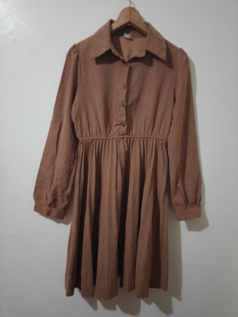Brown Collared Button-Up Pleated Midi Dress (Category: Dresses) located in Cavite. Submitted by rodrycuteshop (Listing ID 1462646673, Image 1). Description: Regular selling price: 299 Now on sale! - Chic brown midi dress - Collared neckline with button-up front - Long sleeves with button cuffs - Elasticated waist for a comfortable fit - Flowy pleated skirt - Soft, comfortable fabric - Versatile for casual or semi-formal occasions - Effortless to 