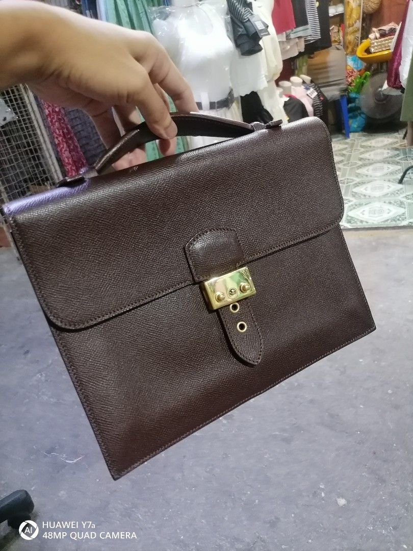 Brown Leather Briefcase "Made in Italy" (Category: Briefcases) located in Naga. Submitted by mrwisethrifter (Listing ID 1462581565, Image 3). Description: - Classic brown leather briefcase - Secure gold-tone clasp closure - Interior embossed "Made in Italy" - Sturdy and comfortable handle - Ideal for documents or a small laptop - Timeless design for professional use.