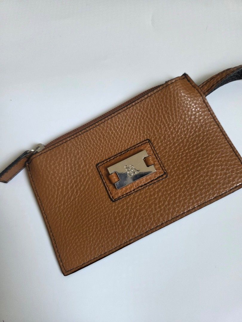 Brown Leather Card Holder with Strap and Zipper (Category: Wallets & Card holders) located in Bacolod City. Submitted by maraline (Listing ID 1462460668, Image 2). Description: • Brand: 100% Authentic XOXO • Color/Material: Cognac Brown / Caramel with a subtle metallic glitter texture. Saffiano or pebbled-style faux/vegan leather • Hardware: Silver-tone metal logo plate and smooth zipper closure • Size: Compact & lightweight (Approx. 6.5" x 4") —