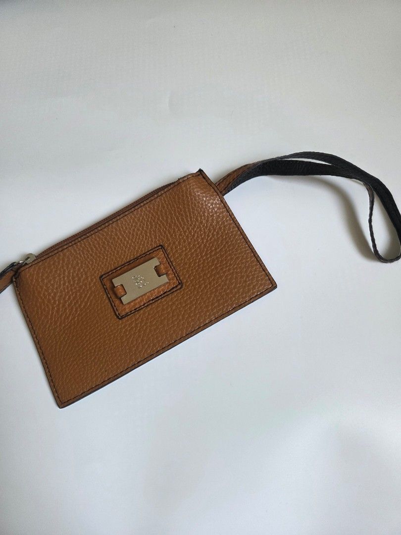 Brown Leather Card Holder with Strap and Zipper (Category: Wallets & Card holders) located in Bacolod City. Submitted by maraline (Listing ID 1462460668, Image 1). Description: • Brand: 100% Authentic XOXO • Color/Material: Cognac Brown / Caramel with a subtle metallic glitter texture. Saffiano or pebbled-style faux/vegan leather • Hardware: Silver-tone metal logo plate and smooth zipper closure • Size: Compact & lightweight (Approx. 6.5" x 4") —