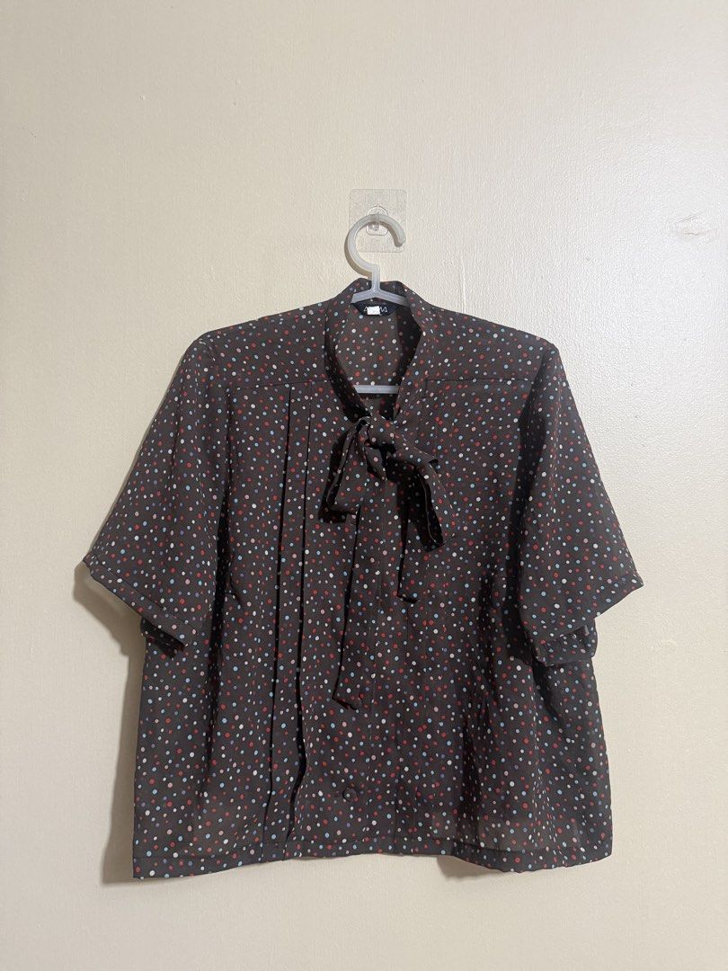 Brown Polka Dot Blouse with Tie Neck (Category: Blouses) located in Quezon City. Submitted by lau_v (Listing ID 1462539615, Image 3). Description: - Brown blouse with a vibrant, colorful polka dot print. - Elegant tie neck detail. - Flattering pleats down the front. - Comfortable short sleeves. - Fits M-L. - length: 20" -widtg: 21" - Easily pairs with skirts or pants..