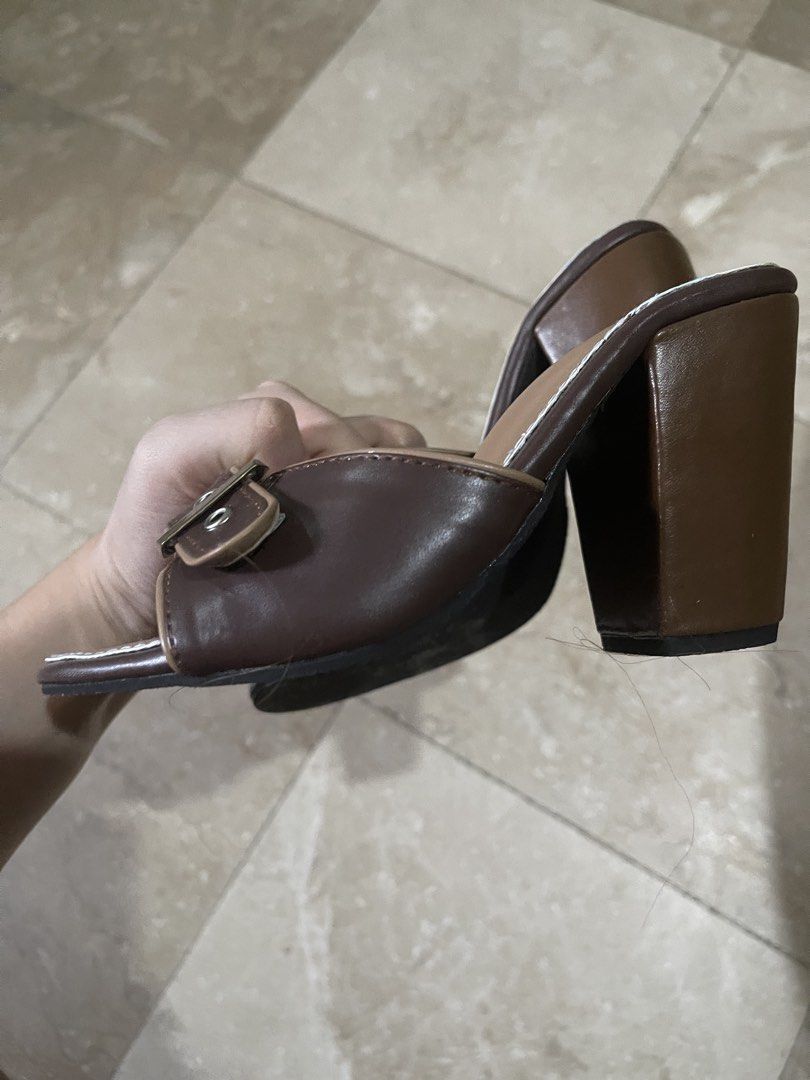 buckle heels brown from Liliw (Category: Heels) located in Quezon City. Submitted by rish40 (Listing ID 1462488865, Image 2). Description: - Stylish brown heeled mules - price is nego - 20cm - Features a chic buckle detail - Open-toe design for a modern look - Comfortable chunky block heel - Easy slip-on style for convenience - Versatile for dressing up or down - Goes with many outfits - Comfortable for walking.