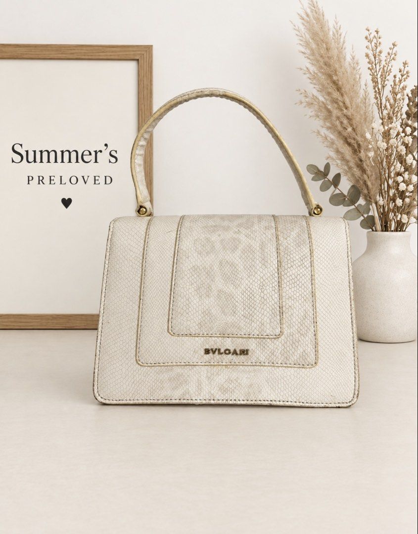 Bulagari Serpenti handle bag (Category: Tote Bags) located in Taguig. Submitted by summers.preloved (Listing ID 1462607170, Image 2). Description: 👜 Bag Details 🤍 Ivory snakeskin-effect textured exterior 🐍 Iconic enamel Serpenti head closure with green eye details 💜 Gold-tone hardware 👜 Structured single top handle 🔒 Secure push-lock flap closure 📂 Expandable accordion-style construction 🖤 Three spacious black-lined compartments 🏷️ Inter
