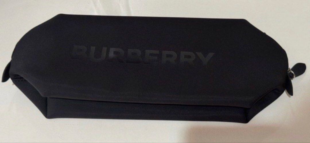 Burberry Black Pouch Cosmetic Bag (Category: Luxury Bags & Wallets) located in Pasay City. Submitted by szepter (Listing ID 1462444315, Image 1). Description: - Authentic Burberry pouch in classic black. - Ideal for organizing makeup, toiletries, or travel essentials. - Secure zipper closure with two convenient pulls. - Made from a soft, durable material resembling neoprene. - Features a subtle, embossed Burberry logo on the front. - Approximate 