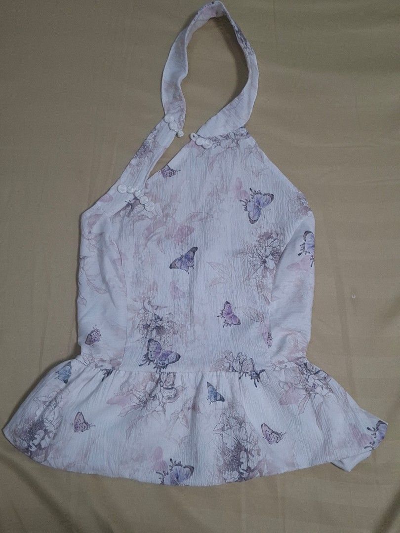 Butterfly Floral Smocked Halter Top (Category: Sleeveless) located in Manila. Submitted by preloved_tweeds_ph (Listing ID 1462615820, Image 2). Description: small to medium loc: pampanga - White halter top - Pretty butterfly and floral print - Smocked back for a comfortable fit - Straps tie at the neck - Textured fabric - Ideal for casual outings or beach trips.