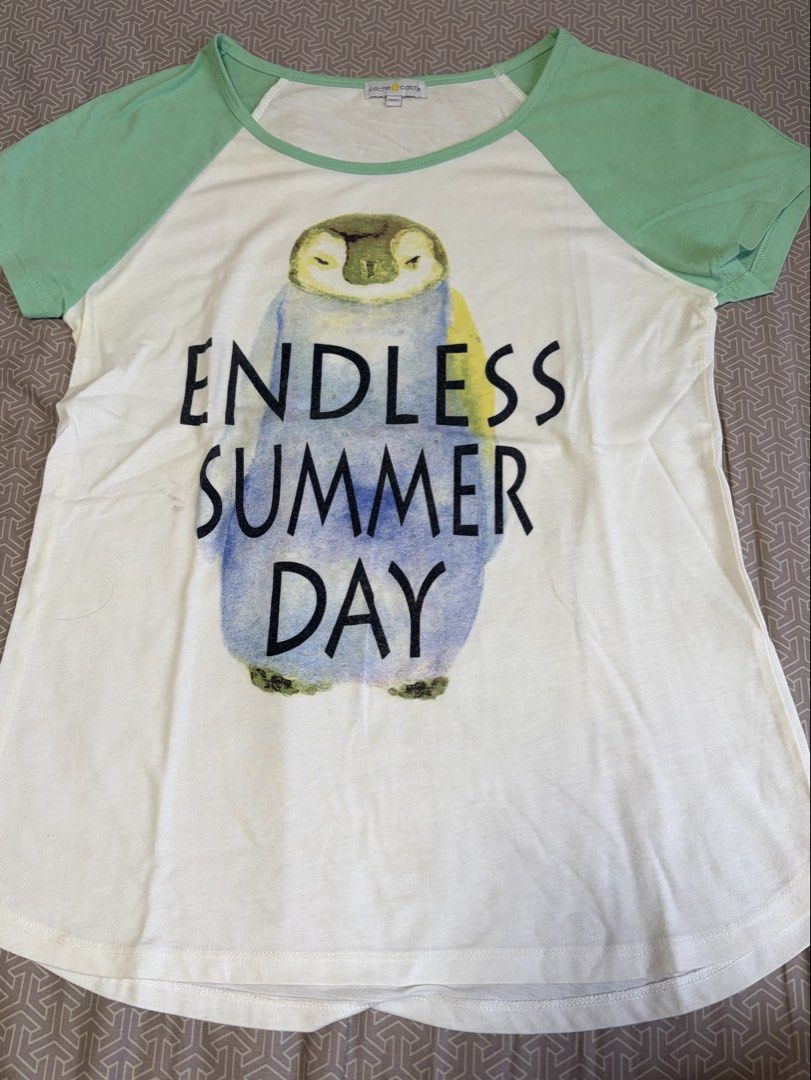 Cache Cache Penguin "Endless Summer Day" T-shirt (Category: Blouses) located in Manila. Submitted by shopmeph (Listing ID 1462650779, Image 1). Description: - Adorable white t-shirt with a charming penguin graphic. - Features the text "Endless Summer Day". - Stylish light green raglan sleeves and neckline. - Made from soft fabric for ultimate comfort. - Relaxed fit, perfect for everyday casual wear..
