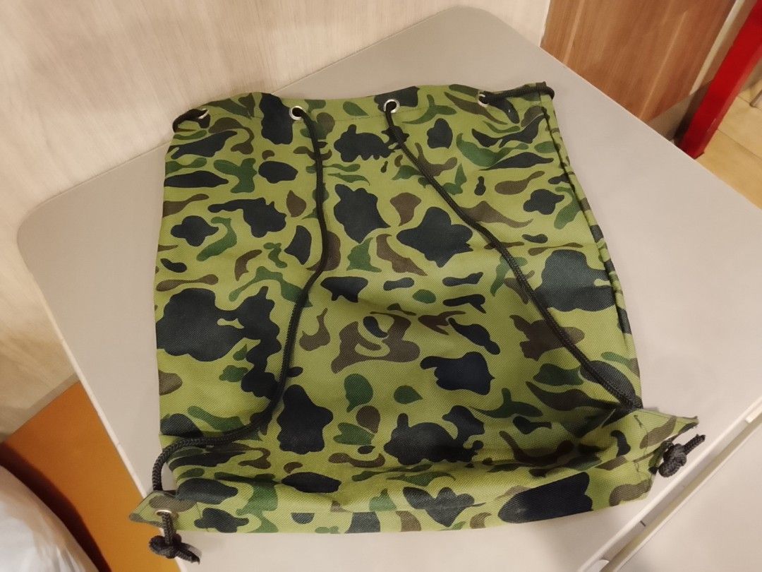 Camouflage pattern drawstring bag (Category: Backpacks) located in Manila. Submitted by newage.vintage (Listing ID 1462501699, Image 1). Description: - excellent condition -no issue - from Japan surplus - length 44cm - width 34cm.
