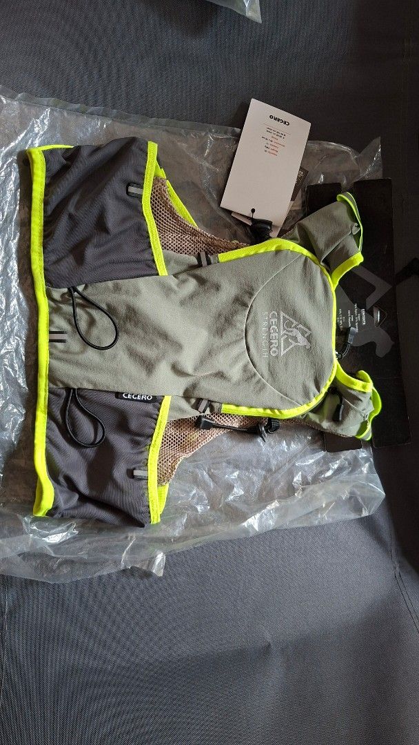 CEGERO STRENGTH Hydration Vest for Running (Category: Other Sports Equipment and Supplies) located in Quezon City. Submitted by glen1014 (Listing ID 1462457704, Image 2). Description: - Grey and neon yellow hydration vest - Lightweight and breathable mesh material - Features multiple pockets for essentials - Adjustable straps ensure a secure and comfortable fit - Ideal for running, hiking, and cycling activities - Brand new, still in original pac