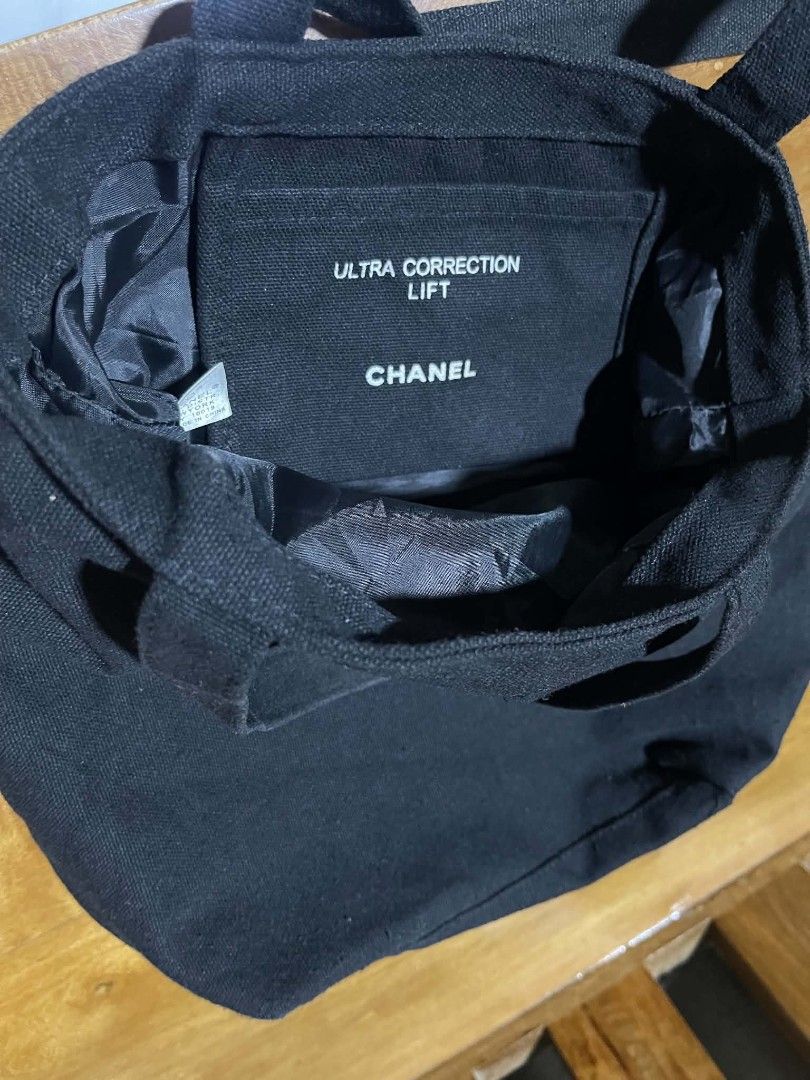 Chanel Black Canvas Tote Bag with CC Logo (Category: Luxury Bags & Wallets) located in Pangantucan. Submitted by calmwhale_cb83a8 (Listing ID 1462589975, Image 3). Description: - Authentic Chanel black canvas tote bag - Features iconic CC logo on the front - Interior pocket printed with 'ULTRA CORRECTION LIFT CHANEL' - Ideal for everyday use or travel - Classic and simple design.