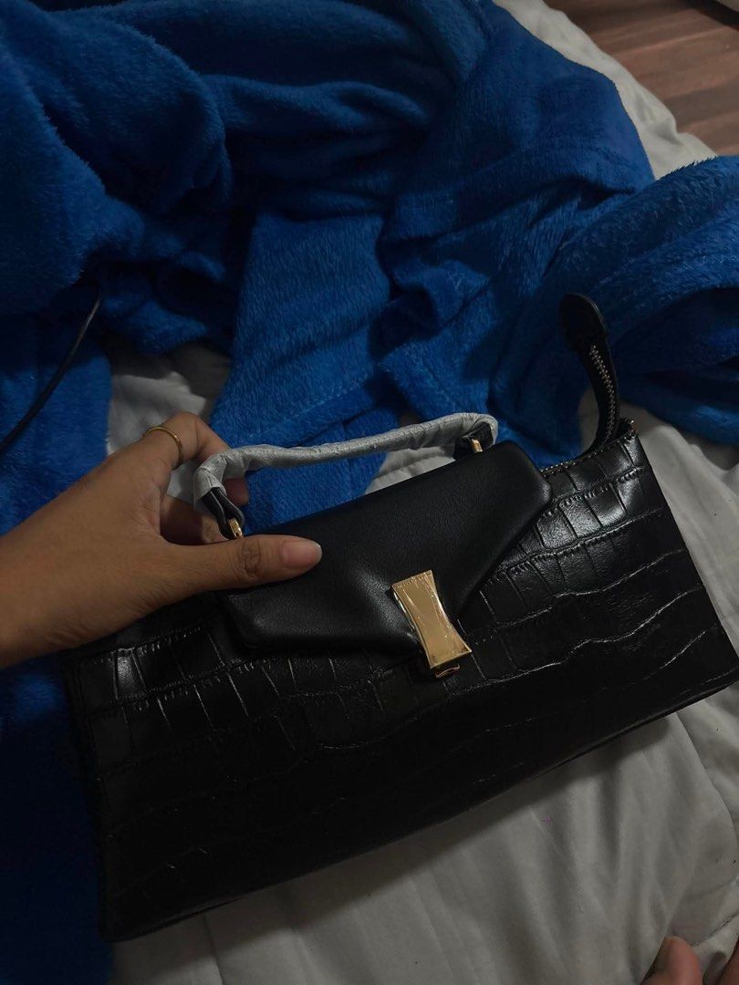 Charles & Keith Black Croc Embossed Top Handle Bag (Category: Luxury Bags & Wallets) located in Manila. Submitted by mcsantiago50683 (Listing ID 1462663091, Image 3). Description: - Brand: Charles & Keith - Color: Black - Texture: Croc embossed - Hardware: Gold details - Handles: Top handle - Strap: Detachable strap included - Closure: Zipper - Interior: Zip pocket - Inclusions: Dust bag and paper bag - Occasion: Versatile, suitable for any event