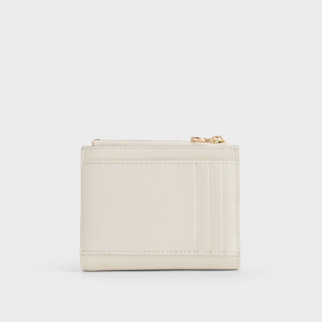 Charles & Keith Hanya Wallet (Cream) (Category: Wallets & Card holders) located in Manila. Submitted by 95ee70b1a701e3b2d80b53b0e4e92c (Listing ID 1462609404, Image 3). Description: Cream Charles & Keith wallet with zip-around closure, wrist strap, card slots, and coin pouch. Gold hardware. Compact and practical. Pass sa lowball .