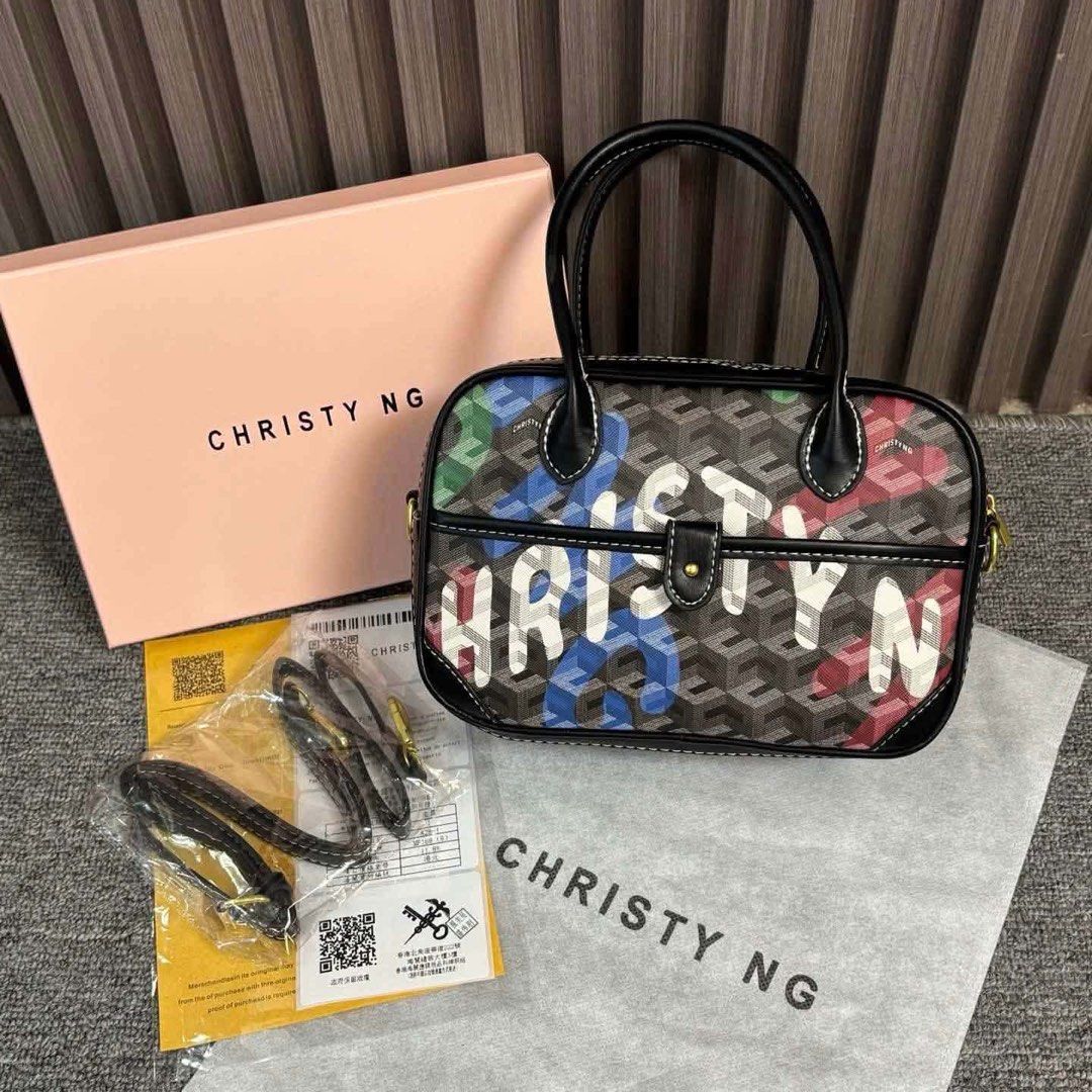 Christy Ng Monogram Print Top Handle Bag (Category: Luxury Bags & Wallets) located in Manila. Submitted by mcsantiago50683 (Listing ID 1462664021, Image 1). Description: - Brand: Christy Ng - Style: Top handle bag - Design: Bold monogram print with colorful lettering - Features: Detachable shoulder strap - Includes: Original dust bag and box - Ideal for: Everyday use or as a statement piece.