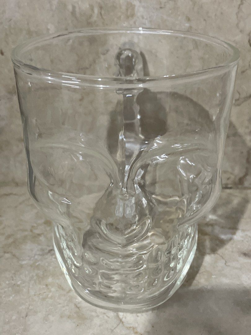 Clear Glass Skull Mug with Handle (Category: Coffee & Tea Tableware) located in San Juan City. Submitted by redrosierose (Listing ID 1462462051, Image 2). Description: - Unique skull-shaped glass mug - Features a sturdy handle for comfortable grip - Versatile: use for beverages or as a decorative display - Ideal for Halloween parties or any spooky-themed event - Made from clear, durable glass - Perfect this upcoming Halloween RFS: Moving Out LOC: