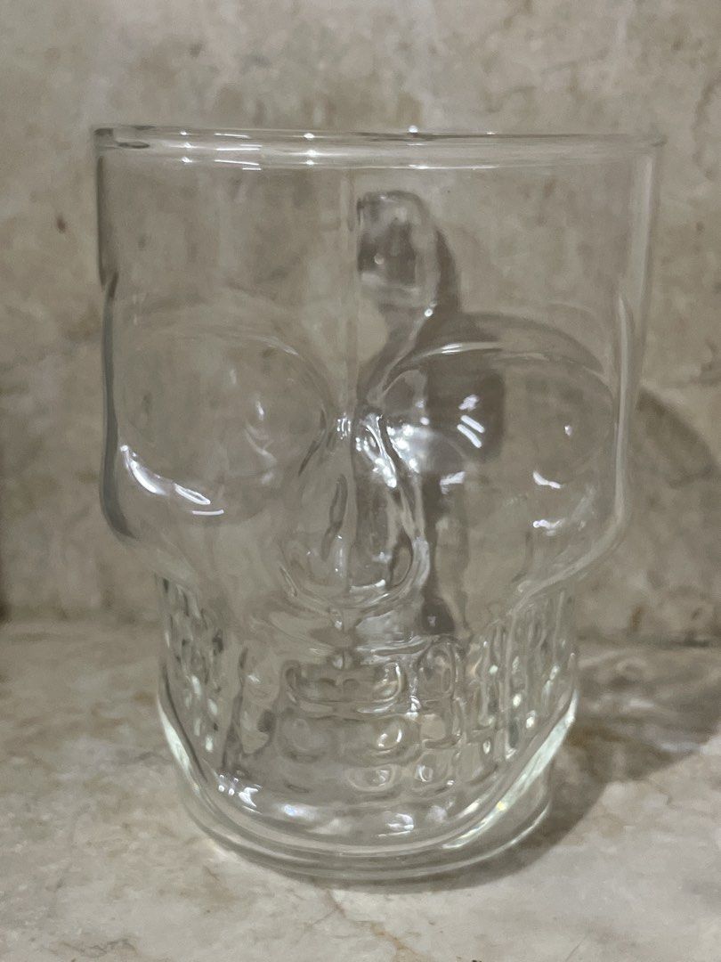 Clear Glass Skull Mug with Handle (Category: Coffee & Tea Tableware) located in San Juan City. Submitted by redrosierose (Listing ID 1462462051, Image 1). Description: - Unique skull-shaped glass mug - Features a sturdy handle for comfortable grip - Versatile: use for beverages or as a decorative display - Ideal for Halloween parties or any spooky-themed event - Made from clear, durable glass - Perfect this upcoming Halloween RFS: Moving Out LOC: