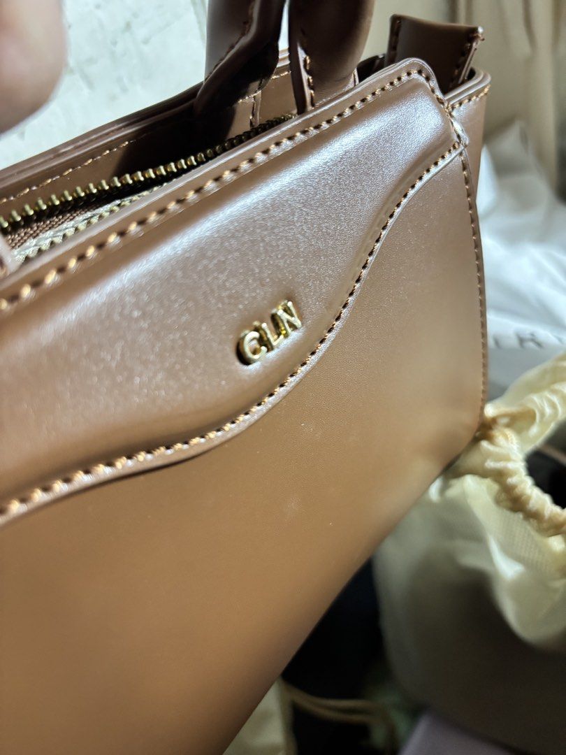 CLN Brown Top Handle Bag (Category: Luxury Bags & Wallets) located in Manila. Submitted by ashsarr (Listing ID 1462558264, Image 2). Description: - Brand: CLN - Color: Brown - Style: Top handle bag - Hardware: Gold - Closure: Zipper - Interior: Multiple pockets - Includes: Dust bag - Ideal for: Everyday use 📍Valenzuela City ₱2,000 (negotiable) Used twice..
