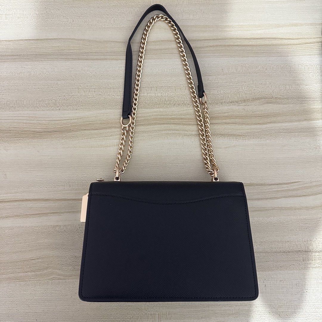 Coach Klare Shoulder Bag (Category: Luxury Bags & Wallets) located in Iligan City. Submitted by yzandrayvo70150 (Listing ID 1462643060, Image 2). Description: - Black Coach Shoulder Bag - Signature print on bottom flap - Elegant gold chain strap - Interior features: 1 zippered pocket, 2 open compartments - Clean inside and out - Versatile: Ideal for everyday errands or evening events.