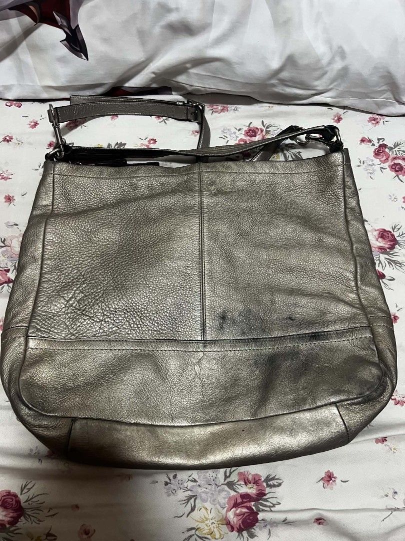 Coach Metallic Leather Hobo Bag (Category: Luxury Bags & Wallets) located in Antipolo. Submitted by happinessprelove (Listing ID 1462556741, Image 2). Description: - Coach hobo bag - Cool metallic pewter color - Genuine leather - Main zip compartment - Adjustable strap - Minor marks on leather (please check photos) - Great for everyday use.