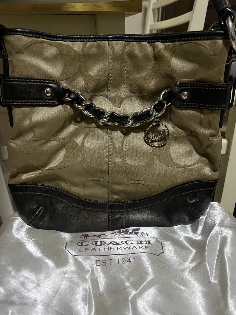 Coach Monogram Canvas Leather Trim Shoulder Bag (Category: Luxury Bags & Wallets) located in Taguig. Submitted by paulll_845 (Listing ID 1462553307, Image 1). Description: - Classic Coach shoulder bag - Beige and brown monogram canvas with black leather trim - Decorative chain detail at the front - Interior zippered pocket and slip pockets - Made in the Philippines - Serial number: E1221-F19730 Price: ₱2,500 .