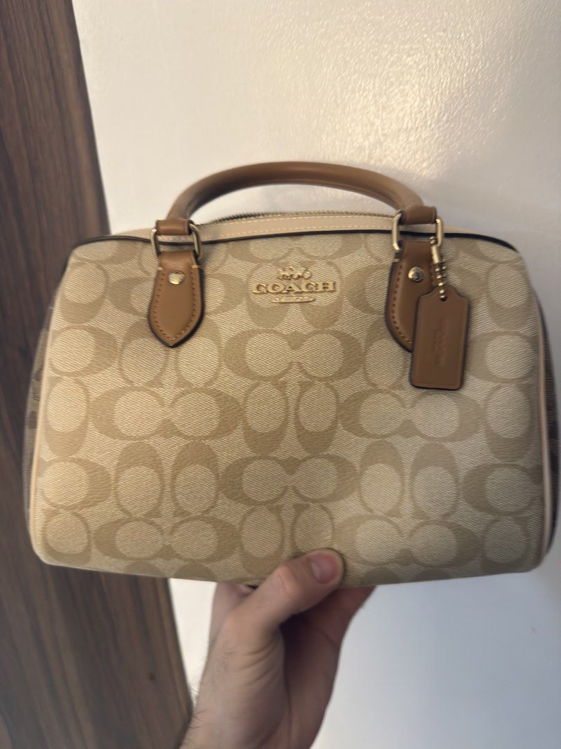 Coach Monogram Canvas Leather Bag (Category: Luxury Bags & Wallets) located in Dasmarinas. Submitted by rjrjrj114 (Listing ID 1462634560, Image 1). Description: - Classic Coach monogram canvas - Tan leather trim and handles - Gold-tone hardware - Zip closure - Interior zip pocket and slip pockets - Great everyday bag Almost new.